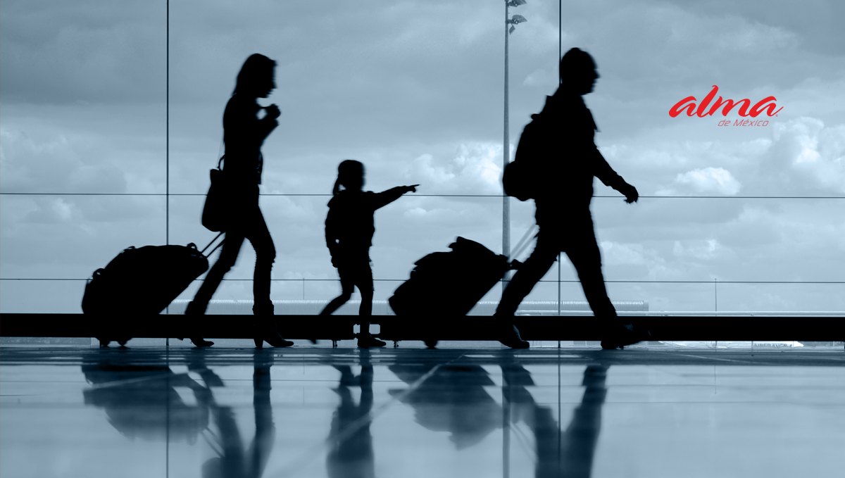 Travelers silhouetted at an airport window in an ALMA ad